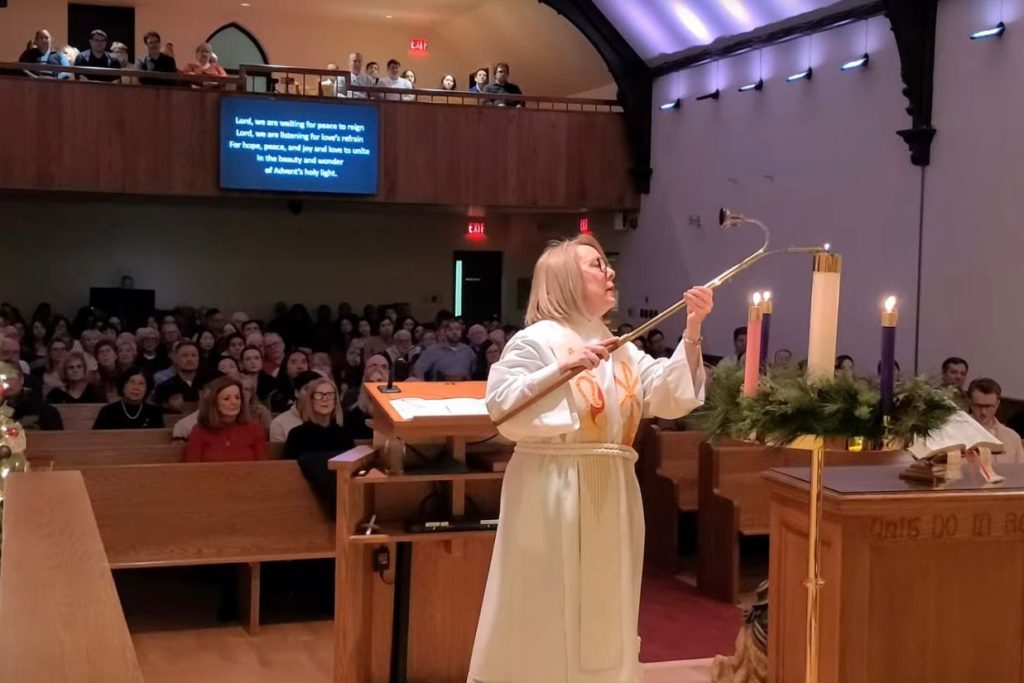 Rev. Lori is lighting the Christ's candle on Christmas Eve Service.